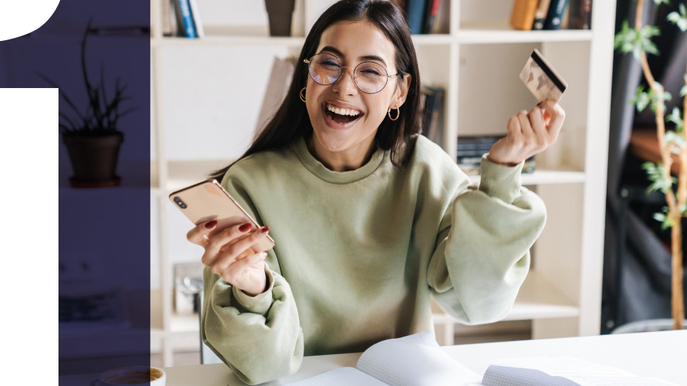 happy womoan with phone and credit card