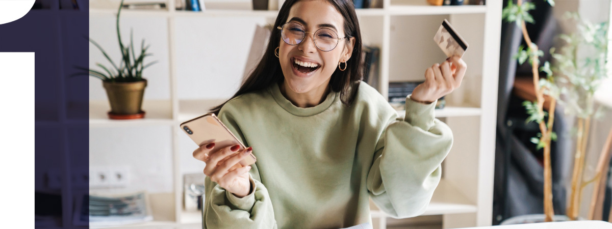 happy womoan with phone and credit card